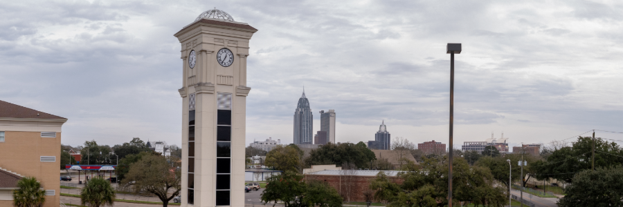 Bishop State Clocktower with the city of Mobile in the background