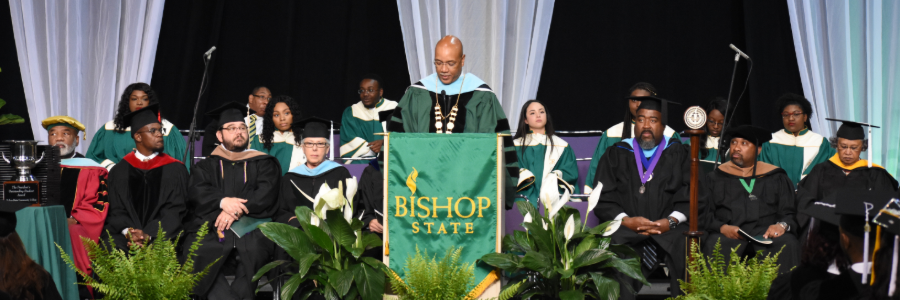 College president standing at podium giving a graduation speech