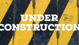 black and yellow stripes with text that reads Under Construction