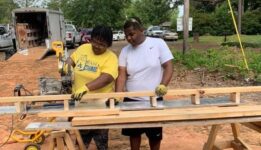 Fix It program members cutting wood for habitat for humanity